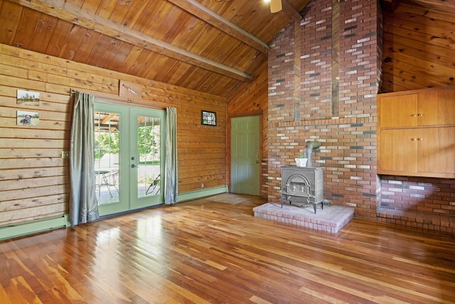 43 Knights Pond Rd, South Berwick, ME 03908 - unfurnished living room featuring french doors, wood-type flooring, a wood stove, high vaulted ceiling, and wood walls