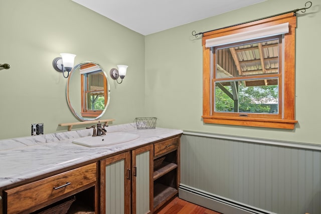 43 Knights Pond Rd, South Berwick, ME 03908 - bathroom with a baseboard heating unit, vanity, a wainscoted wall, and wood finished floors