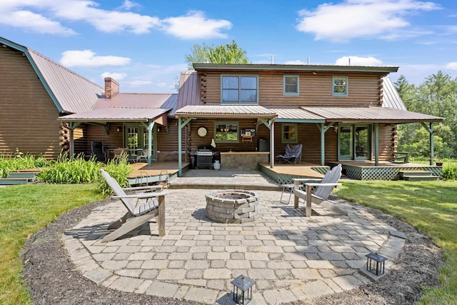 43 Knights Pond Rd, South Berwick, ME 03908 - rear view of property with a fire pit, log exterior, a patio, and a metal roof