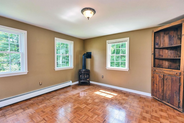 21 Winter Dr, Hooksett, NH 03106 - unfurnished room featuring a wood stove and baseboard heating
