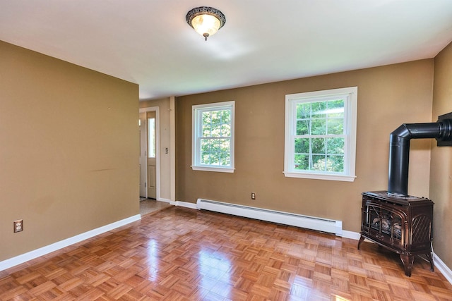 21 Winter Dr, Hooksett, NH 03106 - unfurnished living room with a baseboard radiator and a wood stove