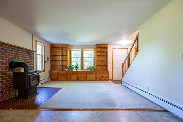 144 Packers Falls Rd, Durham, NH 03824 - unfurnished living room featuring a wood stove, a baseboard heating unit, and plenty of natural light