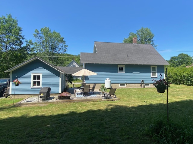 34 Dewey St, Springfield, VT 05156 - rear view of property with a lawn, a patio area, and an outdoor fire pit