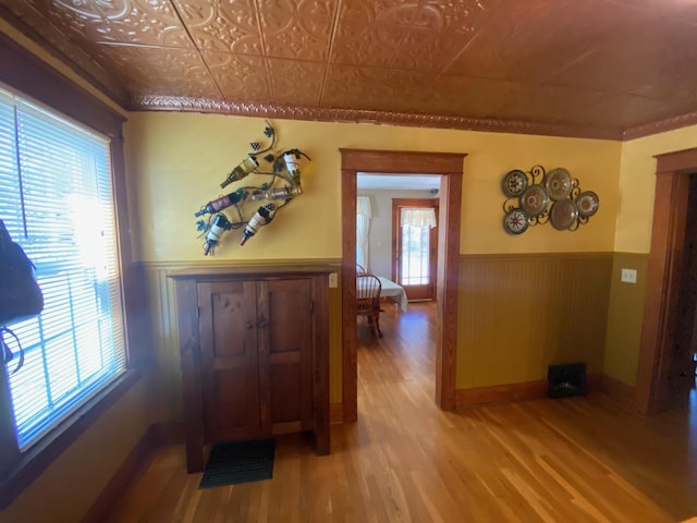 34 Dewey St, Springfield, VT 05156 - corridor with wainscoting, healthy amount of natural light, wood finished floors, wood walls, and an ornate ceiling