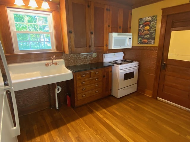 34 Dewey St, Springfield, VT 05156 - kitchen featuring white appliances, wood finished floors, brown cabinets, and dark countertops