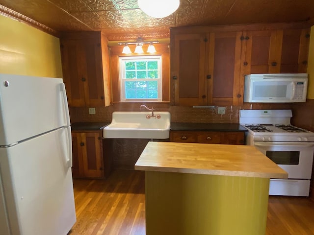 34 Dewey St, Springfield, VT 05156 - kitchen featuring white appliances, butcher block countertops, light wood finished floors, an ornate ceiling, and brown cabinetry
