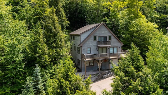 53 Ammonoosuc Dr, Bartlett, NH 03812 - back of house featuring a balcony and a view of trees