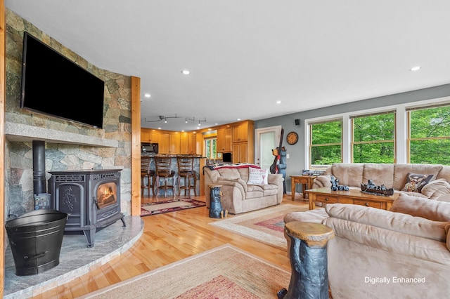 53 Ammonoosuc Dr, Bartlett, NH 03812 - living area with a wood stove, light wood-style floors, healthy amount of natural light, and recessed lighting