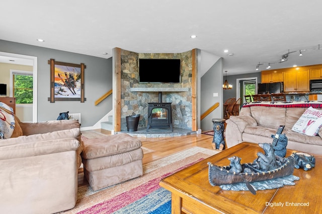 53 Ammonoosuc Dr, Bartlett, NH 03812 - living room with stairway, light wood-style floors, a wood stove, and recessed lighting