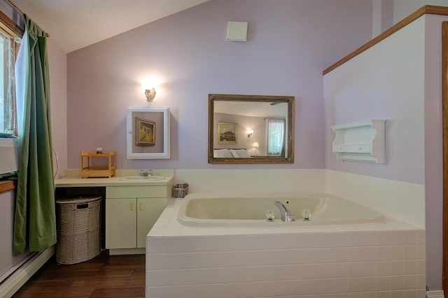 24 Amars Pl, Conway, NH 03818 - full bathroom with a garden tub, vanity, lofted ceiling, and wood finished floors