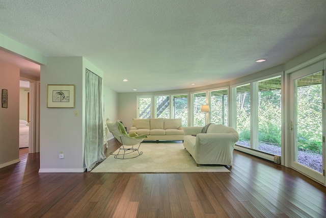 24 Amars Pl, Conway, NH 03818 - living room with baseboard heating, dark wood finished floors, a textured ceiling, and recessed lighting