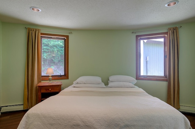 24 Amars Pl, Conway, NH 03818 - bedroom featuring a baseboard heating unit, dark wood finished floors, a textured ceiling, and recessed lighting