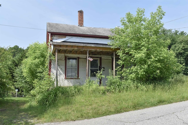 71 Maple St, Brandon, VT 05733 - view of side of home featuring a chimney