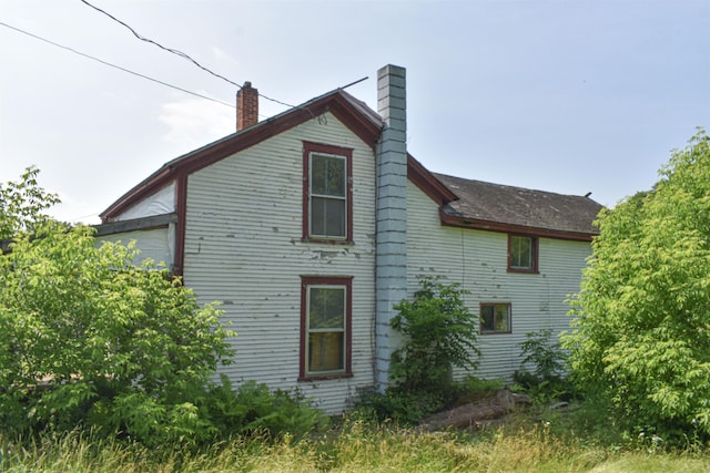 71 Maple St, Brandon, VT 05733 - view of home's exterior featuring a chimney