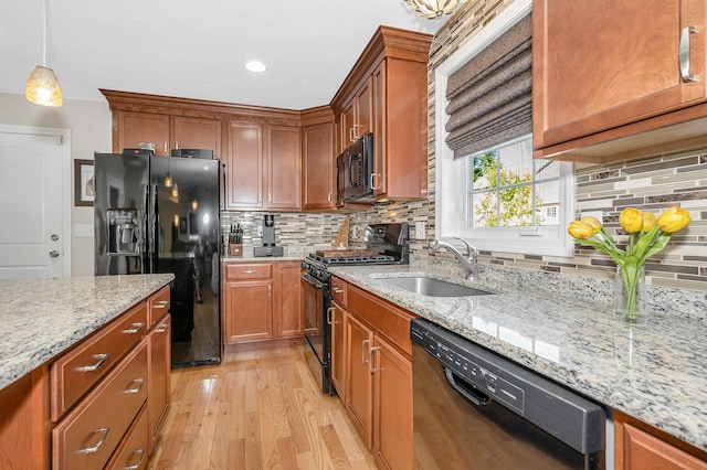 4 Chestnut St, Hudson, NH 03051 - kitchen with black appliances, light wood-style floors, brown cabinets, and recessed lighting