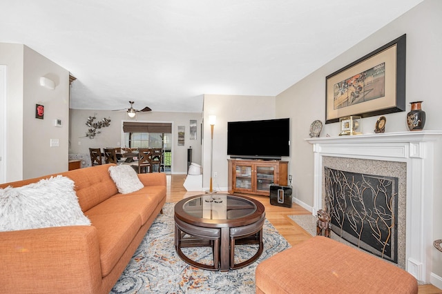 4 Chestnut St, Hudson, NH 03051 - living area featuring light wood-style floors, a ceiling fan, and a fireplace with flush hearth