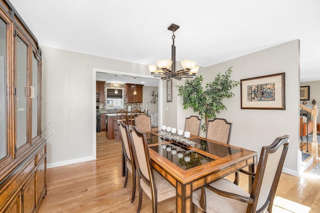 4 Chestnut St, Hudson, NH 03051 - dining area featuring a chandelier and light wood-style flooring