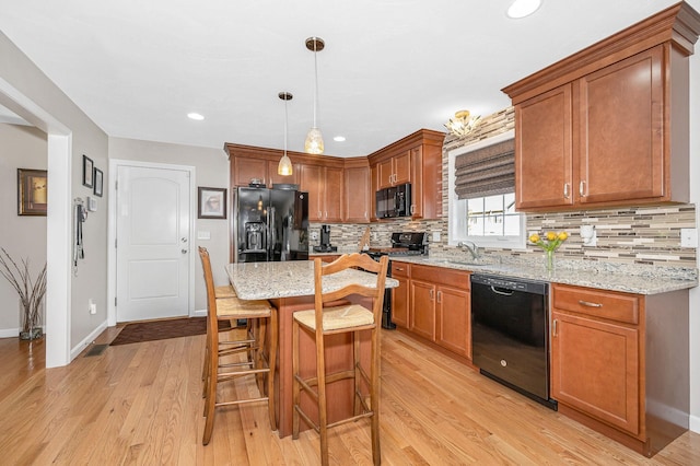 4 Chestnut St, Hudson, NH 03051 - kitchen featuring black appliances, tasteful backsplash, a breakfast bar area, light stone counters, and recessed lighting