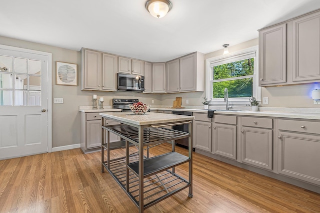 5 Catskill Dr, Merrimack, NH 03054 - kitchen featuring appliances with stainless steel finishes, gray cabinets, light countertops, and light wood-type flooring
