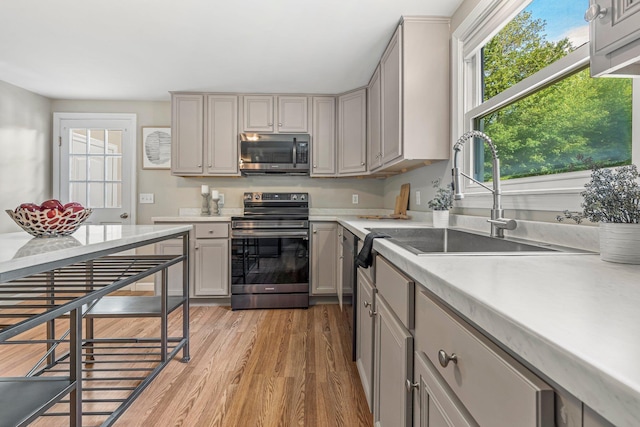 5 Catskill Dr, Merrimack, NH 03054 - kitchen featuring appliances with stainless steel finishes, gray cabinetry, light wood finished floors, and light countertops