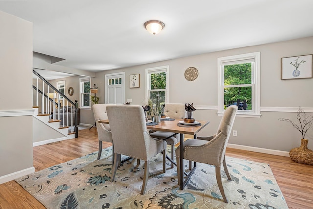5 Catskill Dr, Merrimack, NH 03054 - dining space with plenty of natural light, wood finished floors, and stairs