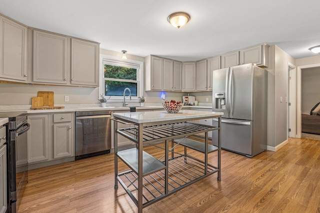 5 Catskill Dr, Merrimack, NH 03054 - kitchen featuring stainless steel appliances, light countertops, light wood-style floors, and gray cabinetry