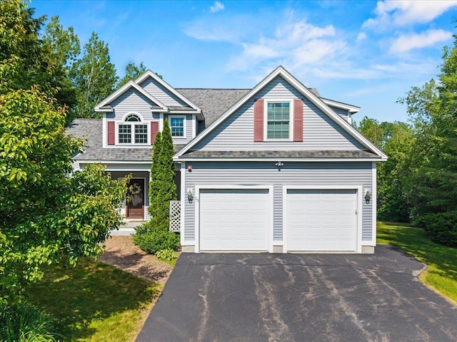 23 Surrey Ln, Laconia, NH 03246 - view of front of home featuring a garage, asphalt driveway, and roof with shingles
