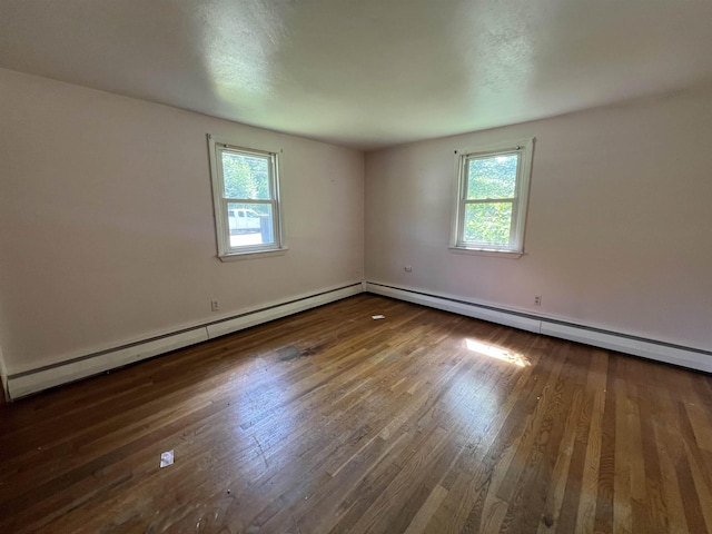 2 Kimball Ter, Danville, NH 03819 - empty room featuring healthy amount of natural light, wood finished floors, and a baseboard heating unit