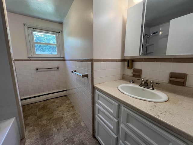 2 Kimball Ter, Danville, NH 03819 - bathroom with a baseboard radiator, vanity, tile walls, a wainscoted wall, and a shower