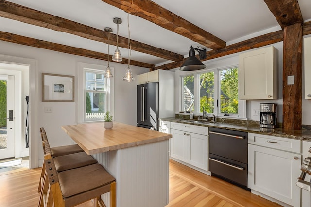 45 Atlantic Ave, North Hampton, NH 03862 - kitchen featuring black dishwasher, wood counters, light wood-type flooring, white cabinets, and beam ceiling