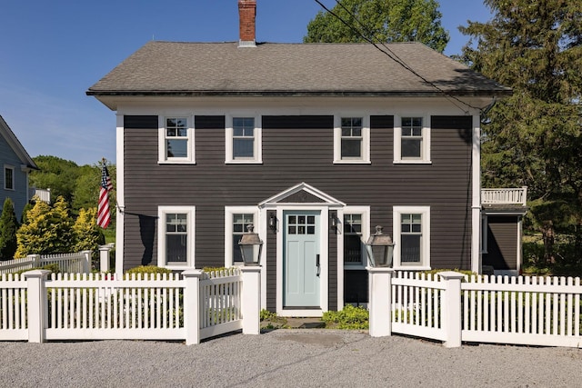 45 Atlantic Ave, North Hampton, NH 03862 - colonial inspired home with a chimney, a fenced front yard, and roof with shingles