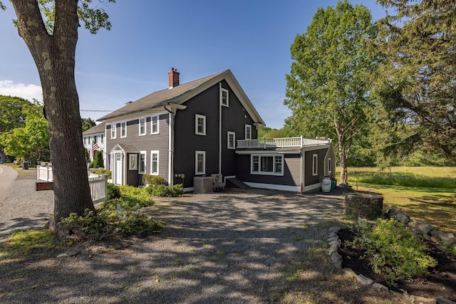 45 Atlantic Ave, North Hampton, NH 03862 - view of home's exterior featuring a chimney and gravel driveway