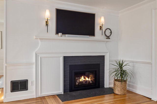 45 Atlantic Ave, North Hampton, NH 03862 - detailed view of a fireplace with flush hearth, wood finished floors, and ornamental molding