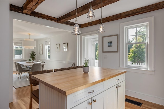 45 Atlantic Ave, North Hampton, NH 03862 - kitchen featuring butcher block counters, light wood-style floors, pendant lighting, white cabinetry, and beam ceiling