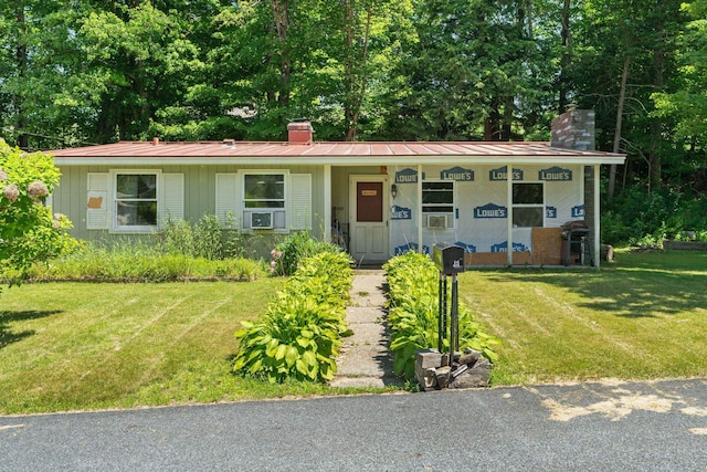 16 Brierbrook Ln, Springfield, VT 05156 - view of front facade with a chimney, a front yard, board and batten siding, and a metal roof