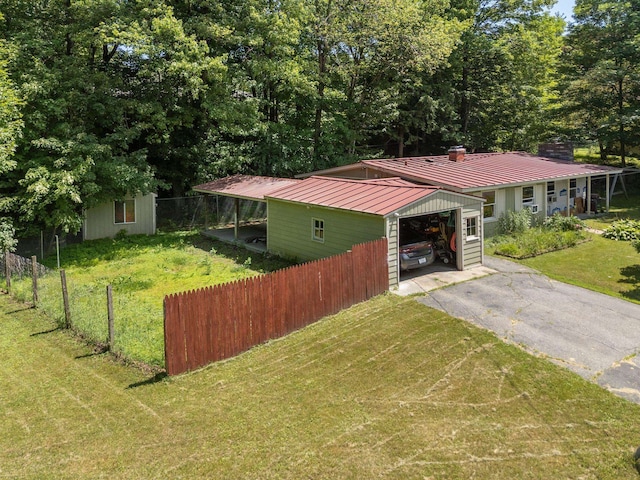 16 Brierbrook Ln, Springfield, VT 05156 - view of front of house with a chimney, driveway, an outbuilding, and an attached garage