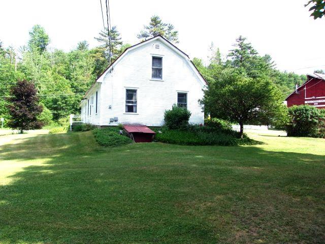 70 Wild Ammonoosuc Rd, Haverhill, NH 03785 - view of side of home featuring a gambrel roof and a yard