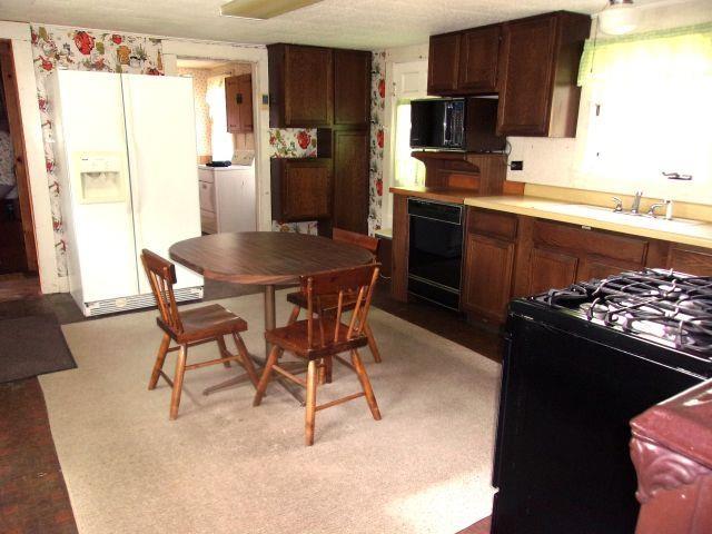 70 Wild Ammonoosuc Rd, Haverhill, NH 03785 - kitchen featuring black appliances and light countertops