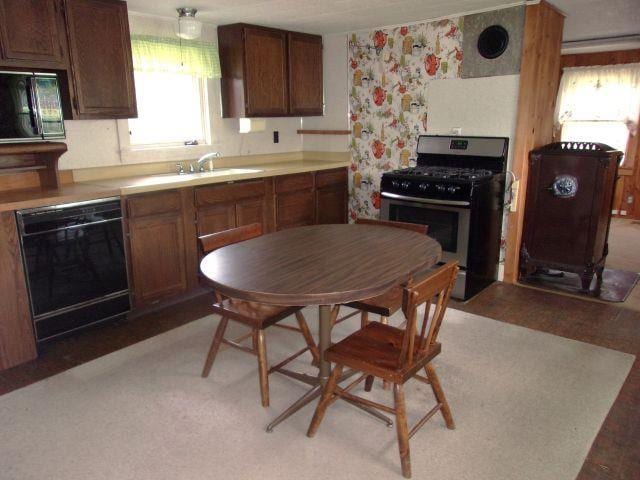 70 Wild Ammonoosuc Rd, Haverhill, NH 03785 - kitchen featuring stainless steel range with gas stovetop, dishwasher, wallpapered walls, and light countertops