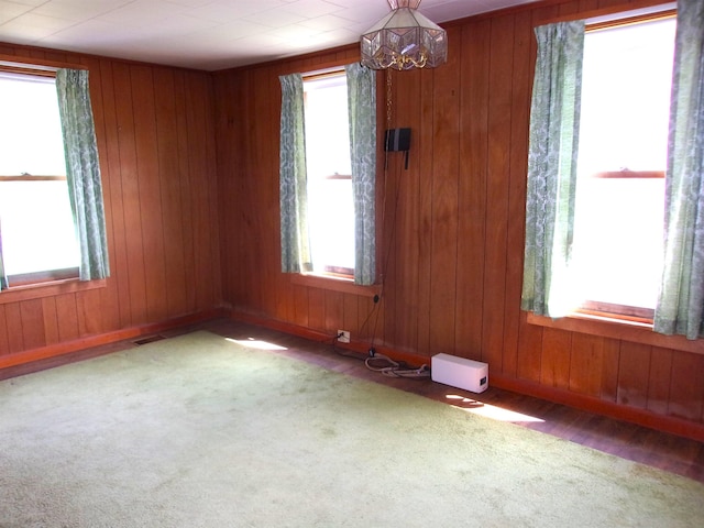 70 Wild Ammonoosuc Rd, Haverhill, NH 03785 - carpeted spare room with a chandelier and wood walls
