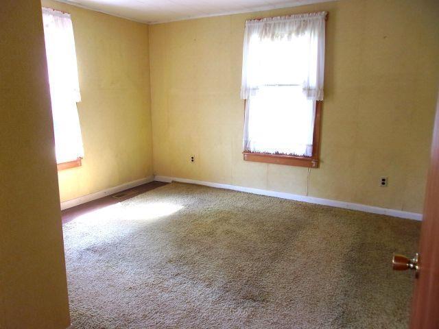 70 Wild Ammonoosuc Rd, Haverhill, NH 03785 - carpeted empty room with plenty of natural light