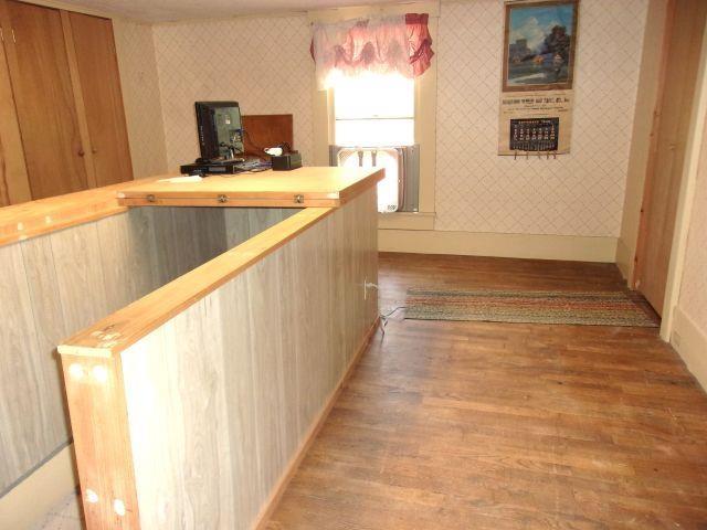 70 Wild Ammonoosuc Rd, Haverhill, NH 03785 - hallway with light wood finished floors, wallpapered walls, and a desk