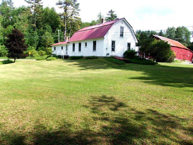 70 Wild Ammonoosuc Rd, Haverhill, NH 03785 - back of property with a gambrel roof, a yard, a metal roof, and a chimney