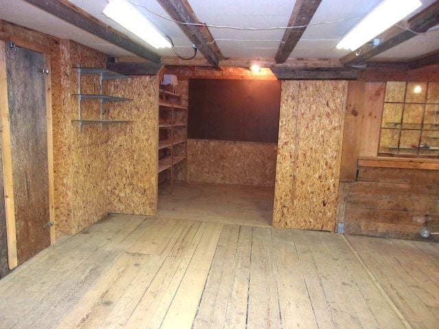 70 Wild Ammonoosuc Rd, Haverhill, NH 03785 - unfinished below grade area with hardwood / wood-style flooring and wood walls