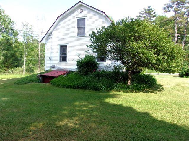 70 Wild Ammonoosuc Rd, Haverhill, NH 03785 - view of property exterior featuring a gambrel roof and a lawn