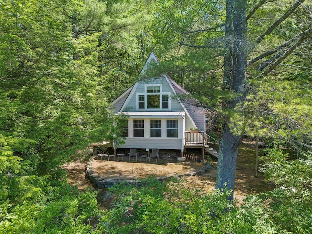 73 Lost Ln, Deering, NH 03244 - back of house with stairway, a forest view, and a deck