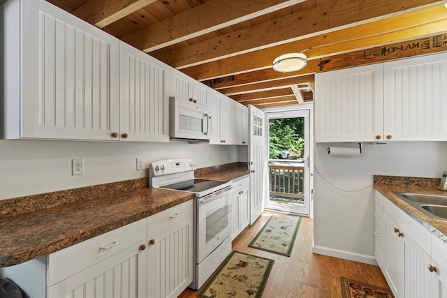 73 Lost Ln, Deering, NH 03244 - kitchen featuring white appliances, light wood finished floors, dark countertops, and white cabinetry