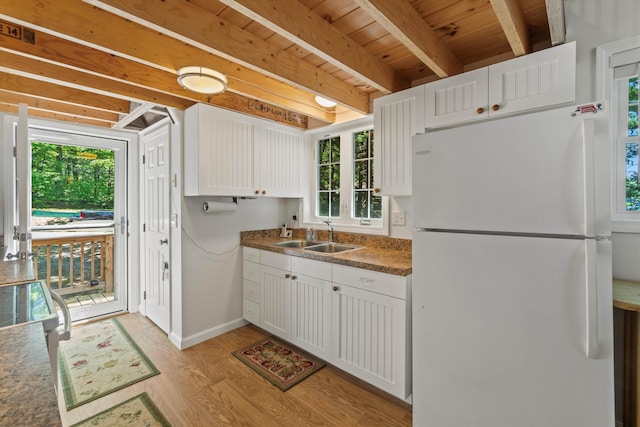 73 Lost Ln, Deering, NH 03244 - kitchen featuring freestanding refrigerator, light wood finished floors, white cabinetry, a wooden ceiling with exposed beams, and dark countertops