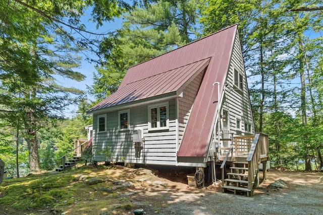 73 Lost Ln, Deering, NH 03244 - view of property exterior with stairs, a metal roof, a standing seam roof, and a wooden deck