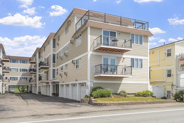 407 Ocean Blvd Unit A11, Hampton, NH 03842 - view of property featuring an attached garage and driveway